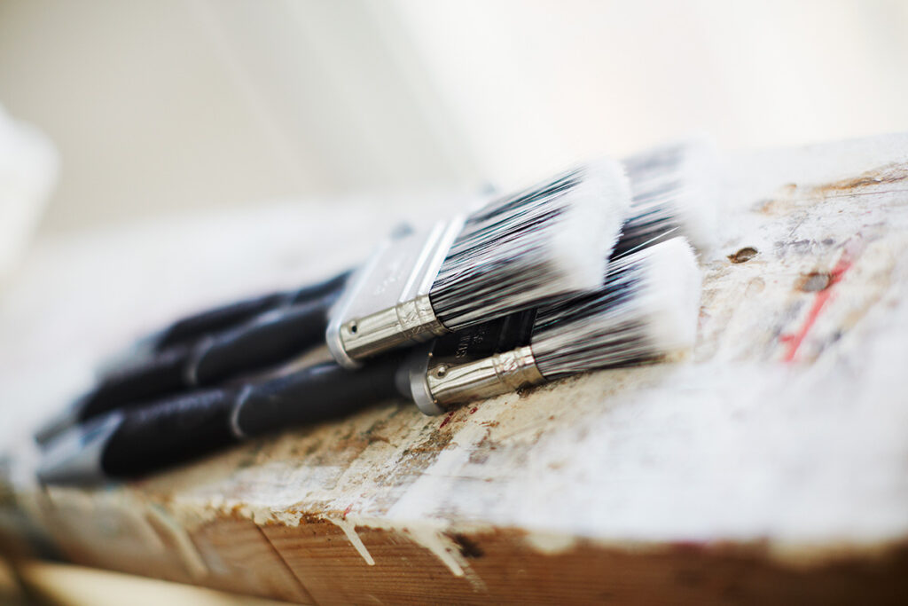 Lacquer brushes lying on a wooden table